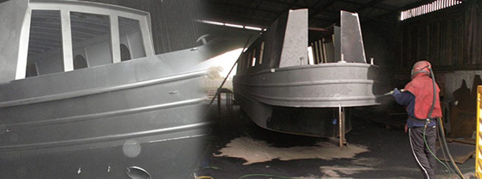 Shot blasting a steel boat hull at Bluewater Boats